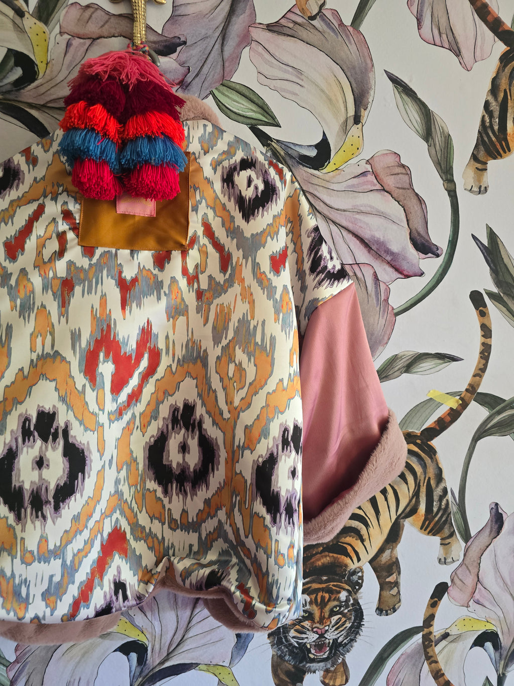 The BLUSHING BABE REVERSIBLE FAUX FUR BOMBER WITH IKAT